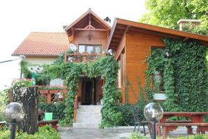 a house with ivy growing on the side of it at Orehite Guest House in Samokov