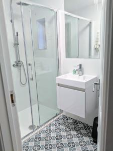 a bathroom with a shower and a sink at TopHome West Hampstead in London