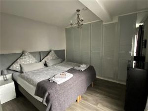 1 dormitorio con 1 cama con toallas en Kallenhard View Apartments, en Adenau