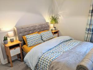 a bedroom with a bed and a couch in it at TopHome West Hampstead in London