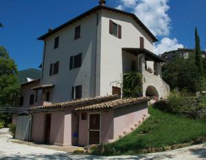 a large white building on top of a hill at Agriturismo Zafferano e Dintorni in SantʼAnatolia di Narco