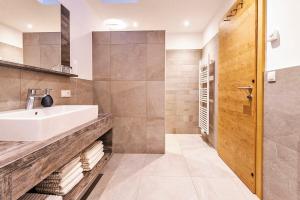 a bathroom with a sink and a shower at Untermathonhof Vöran - Apartments with Farmyard Experience and homemade Breakfast in Verano +53 photos