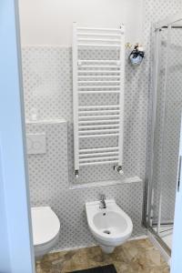 a bathroom with a toilet and a sink at B&B Porta Romana-Language And Art in Ascoli Piceno