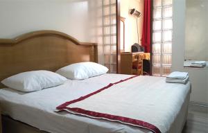 ガジアンテプにあるNil Hotelのベッドルーム1室(ベッド1台、赤と白の毛布付)