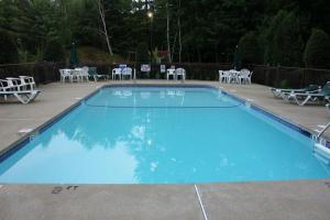 a large blue swimming pool with tables and chairs at Golden Apple Inn in Glen