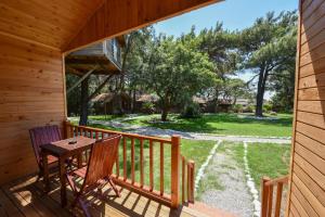 a porch with two chairs and a table at Sea Valley Lodge in Faralya