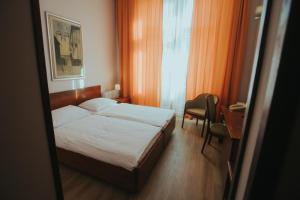 Postel nebo postele na pokoji v ubytování Hotel Central