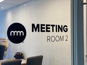 a meeting room sign on a glass door at Menlyn Maine Residence 11th Floor Apartment in Pretoria