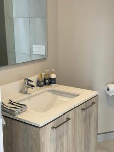 a bathroom with a sink and a mirror at Menlyn Maine Residence 11th Floor Apartment in Pretoria