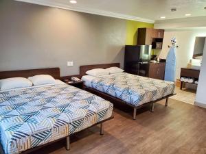 a hotel room with two beds and a kitchen at Studio 6-National City, CA - Naval Base San Diego in National City