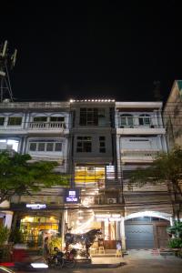 a building with a motorcycle parked in front of it at The BoB Hostel in Bangkok