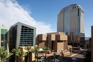 a city with two tall buildings and palm trees at Hyatt Regency Phoenix in Phoenix