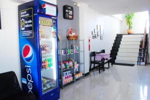 a cocacola soda machine in a store at Plus Hotel in Loei