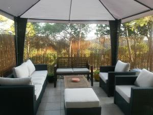 a patio with couches and a table and an umbrella at Villa Hermosa in Begur