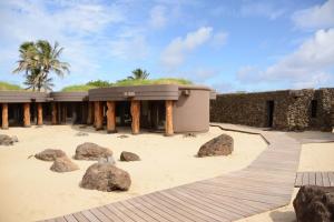 a building with rocks in front of it at Nayara Hangaroa in Hanga Roa