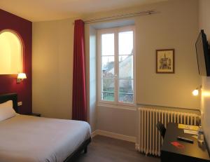 Postel nebo postele na pokoji v ubytování Hôtel Le Dormeux
