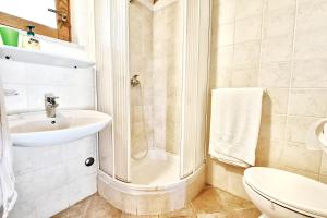 a bathroom with a shower and a sink and a toilet at Adriatico Bungalow in Poreč +21 photos
