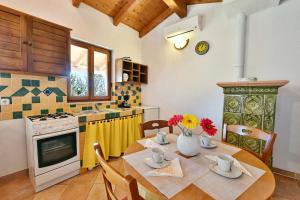 a kitchen with a table with flowers in a kitchen at Adriatico Bungalow in Poreč