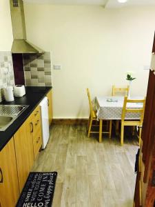 a kitchen with a table and a dining room at Barbers Hall Apartment Town Center in Belmullet