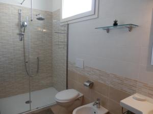 a bathroom with a shower and a toilet and a sink at Casa Lauretta - terrazza con idromassaggio - garage wifi e bici gratuite in Lecce +40 photos