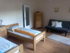 a living room with two beds and a couch at FeWo Gelnhausen in Gründau