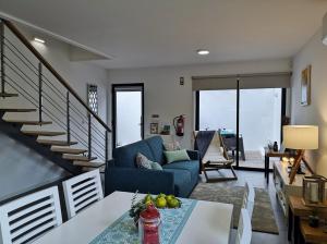 a living room with a blue couch and stairs at Furnas Springs in Furnas