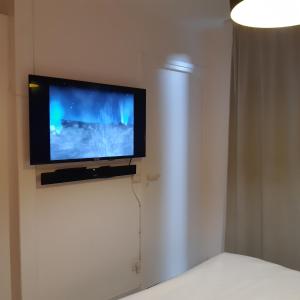 telewizor z płaskim ekranem na ścianie w pokoju w obiekcie STUDIO DJANGO w mieście Saint-François