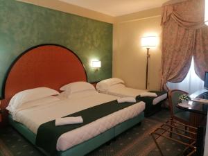 Posteľ alebo postele v izbe v ubytovaní Hotel Principe