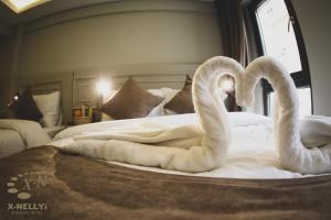 Postel nebo postele na pokoji v ubytování X-NELLYİ HOTEL