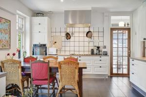 a kitchen with a wooden table and chairs at Sweethome Guesthouse in Esbjerg