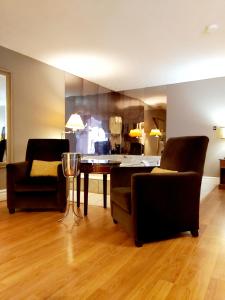 a living room with two chairs and a table at Seely's Motel in Shediac