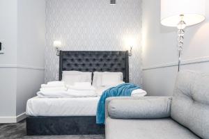 sypialnia z łóżkiem, krzesłem i kanapą w obiekcie Apartamenty Hexus - Ofiar Oświęcimskich - Wrocław centrum Rynek we Wrocławiu