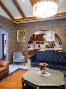 a living room with a couch and a table at Modern Love Villa in Chiang Mai