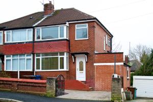 a red brick house with a white door at Beautiful Cozy Home With Free Parking in Manchester