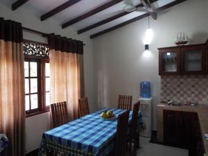 a kitchen with a table with a bowl of fruit on it at Ceylon Epic Villa in Bentota