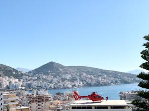 a red helicopter sitting on top of a building at Villa Saral Mar in Sarandë