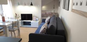 a living room with a couch and a dining room at Lovely Private Flats FREE parking in Novi Sad