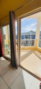 a sliding glass door with a view of a balcony at Spring Palm Estate in St Mary