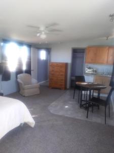 a bedroom with a bed and a table and a kitchen at Mountain view efficiency in Tombstone