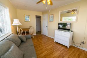 a living room with a couch and a flat screen tv at Aztec Motel Wildwood Crest Beach in Wildwood Crest