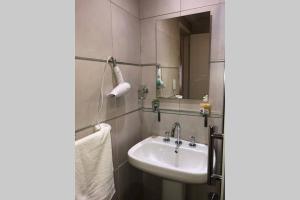 a bathroom with a sink and a mirror at Apart del Puerto 01 in Santa Fe +20 photos