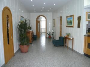 a hallway with chairs and plants in a building at Albergo Belvedere in Scanno