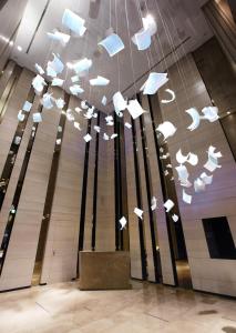 a large group of birds flying through a building at Humble House Taipei in Taipei