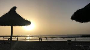 a group of people on the beach at sunset at Dream View in Adeje