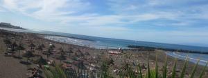a beach with a crowd of people and the ocean at Dream View in Adeje