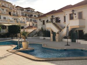 a swimming pool in front of a building at Dream View in Adeje