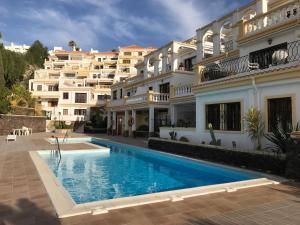 a swimming pool in front of a building at Dream View in Adeje