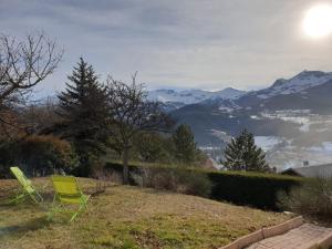 una sedia verde seduta su una collina con montagne sullo sfondo di RAND'UBAYE a Barcelonnette