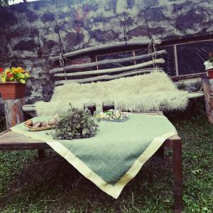 a picnic table with a blanket and flowers on it at Rocky Island in Kazbegi