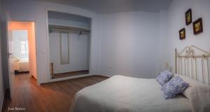 A bed or beds in a room at Santa Angela de la Cruz
